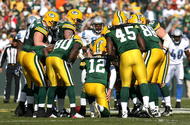 GREEN BAY, WI - OCTOBER 18: Aaron Rodgers #12 of the Green Bay Packers calls a play in the huddle during a game against the Detroit Lions at Lambeau Field on October 18, 2009 in Green Bay, Wisconsin. The Packers defeated the Lions 26-0. (Photo by Jonathan Daniel/Getty Images)