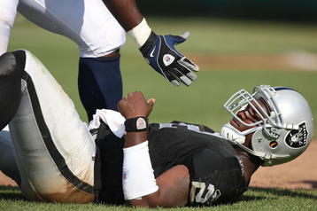 OAKLAND, CA - SEPTEMBER 27:  JaMarcus Russell #2 of the Oakland Raiders is helped up after getting hit against the Denver Broncos on September 27, 2009 during an NFL game at the Oakland-Alameda County Coliseum in Oakland, California.  (Photo by Jed Jacobsohn/Getty Images)
