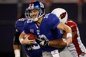 EAST RUTHERFORD, NJ - OCTOBER 25: Eli Manning #10 of the New York Giants is sacked in the second half by Alan Branch #78 of the Arizona Cardinals on October 25, 2009 at Giants Stadium in East Rutherford, New Jersey. (Photo by Jared Wickerham/Getty Images)