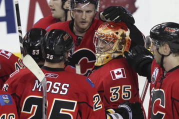 CALGARY, AB - SEPTEMBER 15: Goaltender Leland Irving #35 gets encouragement  from teammates including David Moss #25 and Matt Pelech #56 after the Calgary Flames 4 - 1 loss to the Edmonton Oilers in NHL preseason action on September 15, 2009 at the Pengrowth Saddledome in Calgary, Alberta. (Photo by Mike Ridewood/Getty Images)