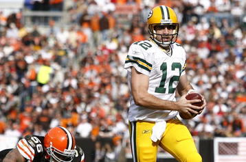 CLEVELAND, OH - OCTOBER 25:  Aaron Rodgers #12 of the Green Bay Packers runs by Kaluka Maiava #56 of the Cleveland Browns at Cleveland Browns Stadium on October 25, 2009 in Cleveland, Ohio.  (Photo by Matt Sullivan/Getty Images)
