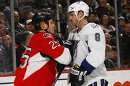 OTTAWA, ON - OCTOBER 15:  Matt Walker #8 of the Tampa Bay Lightning takes on Chris Neil #25 of the Ottawa Senators during a game at Scotiabank Place on October 15, 2009 in Ottawa, Canada.  The Ottawa Senators defeated the Tampa Bay Lightning 7-1.  (Photo by Phillip MacCallum/Getty Images)