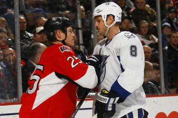 OTTAWA, ON - OCTOBER 15:  Matt Walker #8 of the Tampa Bay Lightning takes on Chris Neil #25 of the Ottawa Senators during a game at Scotiabank Place on October 15, 2009 in Ottawa, Canada.  The Ottawa Senators defeated the Tampa Bay Lightning 7-1.  (Photo by Phillip MacCallum/Getty Images)