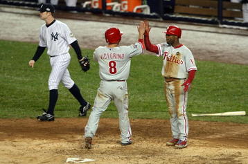 NEW YORK - OCTOBER 28:  Jimmy Rollins #11 (R) and Shane Victorino #8 of the Philadelphia Phillies celebrate after they scored on a 2-run single by Raul Ibanez #29 in the top of the eighth inning as David RObertson #30 (L) of the New York Yankees looks on in Game One of the 2009 MLB World Series at Yankee Stadium on October 28, 2009 in the Bronx borough of New York City.  (Photo by Nick Laham/Getty Images)