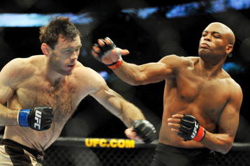 PHILADELPHIA - AUGUST 08:  Anderson Silva (R) throws a right punch to Forrest Griffin during their light heavyweight bout at UFC 101: Declaration at the Wachovia Center on August 8, 2009 in Philadelphia, Pennsylvania.  (Photo by Jon Kopaloff/Getty Images)