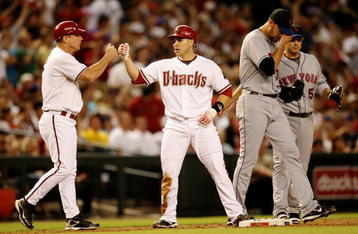 PHOENIX - AUGUST 10: Miguel Montero #26 of the Arizona Diamondbacks celebrates with third base coach Chip Hale #5 after hitting a triple as pitcher Mike Pelfrey #34 of the New York Mets walks back to the mound during the game at Chase Field on August 10, 2009 in Phoenix, Arizona. (Photo by Christian Petersen/Getty Images)