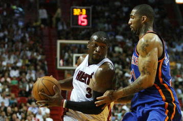 MIAMI - OCTOBER 28:  Dwyane Wade #3 of the Miami Heat drives past Wilson Chandler #21 of the New York Knicks at AmericanAirlines Arena on October 28, 2009 in Miami, Florida. NOTE TO USER: User expressly acknowledges and agrees that, by downloading and/or using this Photograph, user is consenting to the terms and conditions of the Getty Images License Agreement.  (Photo by Doug Benc/Getty Images)
