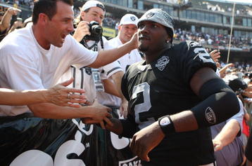OAKLAND, CA - SEPTEMBER 27:  JaMarcus Russell #2 of the Oakland Raiders meets fans before his game against the Denver Broncos on September 27, 2009 during an NFL game at the Oakland-Alameda County Coliseum in Oakland, California.  (Photo by Jed Jacobsohn/Getty Images)