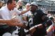 OAKLAND, CA - SEPTEMBER 27:  JaMarcus Russell #2 of the Oakland Raiders meets fans before his game against the Denver Broncos on September 27, 2009 during an NFL game at the Oakland-Alameda County Coliseum in Oakland, California.  (Photo by Jed Jacobsohn/Getty Images)