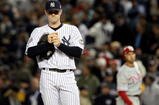 NEW YORK - OCTOBER 28:  David Robertson #30 of the New York Yankees reacts after he gave up a 2-run single to Raul Ibanez #29 (R) of the Philadelphia Phillies in the top of the eighth inning of Game One of the 2009 MLB World Series at Yankee Stadium on October 28, 2009 in the Bronx borough of New York City.  (Photo by Jed Jacobsohn/Getty Images)