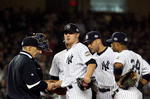 NEW YORK - OCTOBER 28:  Manager Joe Girardi (L) of the New York Yankees takes Phil Hughes #65 out of the game in the top of the eighth inning against the Philadelphia Phillies in Game One of the 2009 MLB World Series at Yankee Stadium on October 28, 2009 in the Bronx borough of New York City.  (Photo by Jim McIsaac/Getty Images)