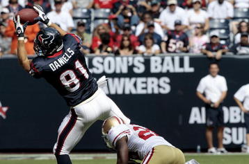 HOUSTON - OCTOBER 25:  Tight-end Owen Daniels #81 of the Houston Texans completes a pass in front of safety Mark Roman #26 of the San Francisco 49ers at Reliant Stadium on October 25, 2009 in Houston, Texas.  (Photo by Bob Levey/Getty Images)