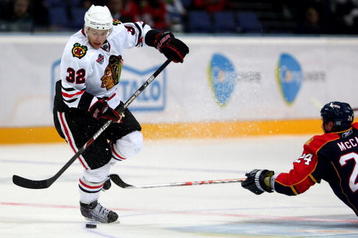 HELSINKI, FINLAND - OCTOBER 03:  #32 Kris Versteeg of the Chicago Blackhawks avoids a tackle from #24 Bryan McCabe of the Florida Panthers during The Compuware/NHL Premiere Helsinki series match between the Chicago Blackhawks and the Florida Panthers at the Hartwall Areena on October 3, 2009 in Helsinki, Finland.  (Photo by Richard Heathcote/Getty Images)