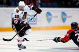 HELSINKI, FINLAND - OCTOBER 03:  #32 Kris Versteeg of the Chicago Blackhawks avoids a tackle from #24 Bryan McCabe of the Florida Panthers during The Compuware/NHL Premiere Helsinki series match between the Chicago Blackhawks and the Florida Panthers at the Hartwall Areena on October 3, 2009 in Helsinki, Finland.  (Photo by Richard Heathcote/Getty Images)