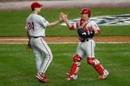 NEW YORK - OCTOBER 28:  (L-R) Cliff Lee #34 and Carlos Ruiz #51 of the Philadelphia Phillies celebrate after their 6-1 win against the New York Yankees in Game One of the 2009 MLB World Series at Yankee Stadium on October 28, 2009 in the Bronx borough of New York City.  (Photo by Jared Wickerham/Getty Images)