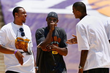 LOS ANGELES, CA - JUNE 17:  (L-R) Shannon Brown, Kobe Bryant and Trevor Ariza of the Los Angeles Lakers celebrate on stage during the 2009 NBA Championship Victory Parade and rally at the Los Angeles Memorial Coliseum on June 17, 2009 in Los Angeles, California.  (Photo by Jeff Gross/Getty Images)