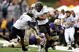 SEATTLE - OCTOBER 24:  Linebacker Kenny Rowe #58 of the Oregon Ducks returns an interception against Mykenna Ikehara #51 of the Washington Huskies on October 24, 2009 at Husky Stadium in Seattle, Washington. The Ducks defeated the Huskies 43-19. (Photo by Otto Greule Jr/Getty Images)