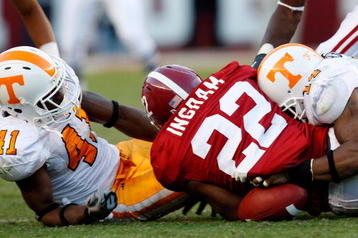 TUSCALOOSA, AL - OCTOBER 24:  Dennis Rogan #41 and Eric Berry #14 of the Tennessee Volunteers force a fumble by Mark Ingram #22 of the Alabama Crimson Tide at Bryant-Denny Stadium on October 24, 2009 in Tuscaloosa, Alabama.  (Photo by Kevin C. Cox/Getty Images)