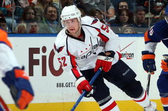 UNIONDALE, NY - OCTOBER 24:  Mike Green #52 of the Washington Capitals skates against Matt Moulson #26 of the New York Islanders on October 24, 2009 at Nassau Coliseum in Uniondale, New York. The Capitals won the game 3-2 in overtime.  (Photo by Jim McIsaac/Getty Images)