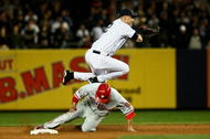 NEW YORK - OCTOBER 29: Derek Jeter #2 of the New York Yankees turns a double play against Shane Victorino #8 of the Philadelphia Phillies in Game Two of the 2009 MLB World Series at Yankee Stadium on October 29, 2009 in the Bronx borough of New York City. (Photo by Chris McGrath/Getty Images)