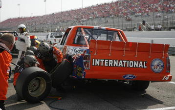 MADISON, IL - SEPTEMBER 12: The pit crew for Rick Crawford, driver of the #14 Cirle Bar/International Truck Engine Ford work to change tires on the truck during the Camping World truck race Copart 200 at the Gateway International Raceway September 12, 2009 in Madison, Illinois. (Photo by John Sommers II/Getty Images)