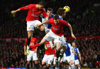 MANCHESTER, UNITED KINGDOM - FEBRUARY 21:  Cristiano Ronaldo of Manchester United goes up for a header with team mate Jonny Evans (R) during the Barclays Premier League match between Manchester United and Blackburn Rovers at Old Trafford on February 21, 2009 in Manchester, England.  (Photo by Jamie McDonald/Getty Images)