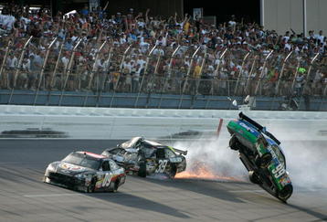 TALLADEGA, AL - APRIL 26:  Carl Edwards, driver of the #99 Claritin Ford, goes airborne as Ryan Newman, driver of the #39 Steweart-Haas Racing Chevrolet suffers damage and Brad Keselowski, driver of the #09 Miccosukee Indian Gaming Chevrolet drives at the conclusion of the NASCAR Sprint Cup Series Aaron's 499 at Talladega Superspeedway on April 26, 2009 in Talladega, Alabama.  (Photo by Jerry Markland/Getty Images for NASCAR)