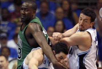 ORLANDO, FL - MAY 08:  J.J. Redick #7 of the Orlando Magic (C) is fouled by Kendrick Pewrkins #43 of the Boston Celtics (L) in Game Three of the Eastern Conference Semifinals during the 2009 NBA Playoffs at Amway Arena on May 8, 2009 in Orlando, Florida. NOTE TO USER: User expressly acknowledges and agrees that, by downloading and or using this photograph, User is consenting to the terms and conditions of the Getty Images License Agreement.  (Photo by Marc Serota/Getty Images)