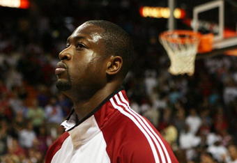 MIAMI - OCTOBER 28:  Dwyane Wade #3 of the Miami Heat stands for the National Anthem before taking on the New York Knicks at AmericanAirlines Arena on October 28, 2009 in Miami, Florida. The Heat defeated the Knicks 115-93. NOTE TO USER: User expressly acknowledges and agrees that, by downloading and/or using this Photograph, user is consenting to the terms and conditions of the Getty Images License Agreement.  (Photo by Doug Benc/Getty Images)