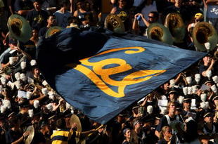 PASADENA, CA - OCTOBER 17: A California Golden Bears cheerleader waves a flag in front of the Cal band and visitor's section in the game with the UCLA Bruins on October 17, 2009 at the Rose Bowl in Pasadena, California. Cal won 45-26. (Photo by Stephen Dunn/Getty Images)