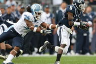 EAST HARTFORD, CT - SEPTEMBER 12:  Jasper Howard #6 of the Connecticut Huskies carries the ball as Johnny White #34 of the North Carolinia Tar Heels tries to make the tackle on September 12, 2009 at Rentschler Field in East Hartford, Connecticut.  (Photo by Elsa/Getty Images)
