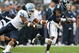 EAST HARTFORD, CT - SEPTEMBER 12:  Jasper Howard #6 of the Connecticut Huskies carries the ball as Johnny White #34 of the North Carolinia Tar Heels tries to make the tackle on September 12, 2009 at Rentschler Field in East Hartford, Connecticut.  (Photo by Elsa/Getty Images)