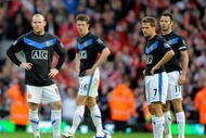 LIVERPOOL, ENGLAND - OCTOBER 25: Wayne Rooney (L) and Michael Owen of Manchester United prepare to kick off after conceding a second goal during the Barclays Premier League match between Liverpool and Manchester United at Anfield on October 25, 2009 in Liverpool, England. (Photo by Michael Regan/Getty Images)