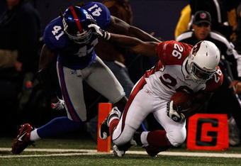 EAST RUTHERFORD, NJ - OCTOBER 25:  Beanie Wells #26 of the Arizona Cardinals stiff arms C.C. Brown #41 of the New York Giants as he runs in for a touchdown on October 25, 2009 at Giants Stadium in East Rutherford, New Jersey.  (Photo by Jared Wickerham/Getty Images)