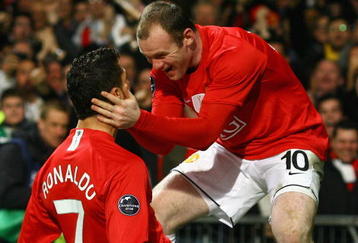 MANCHESTER, UNITED KINGDOM - MARCH 11:  Cristiano Ronaldo of Manchester United is congratulated by team mate Wayne Rooney after scoring his team's second goal during the UEFA Champions League Round of Sixteen, Second Leg match between Manchester United and Inter Milan at Old Trafford on March 11, 2009 in Manchester, England.  (Photo by Alex Livesey/Getty Images)