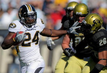 BOULDER, CO - OCTOBER 31:  Derrick Washington #24 of the Missouri Tigers picks up yardage as he fends off Ray Polk #26 of the Colorado Buffaloes at Folsom Field on October 31, 2009 in Boulder, Colorado.  (Photo by Doug Pensinger/Getty Images)