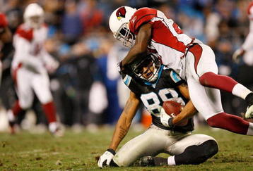 CHARLOTTE, NC - JANUARY 10: Dante Rosario #88 of the Carolina Panthers is tackled by Antrel Rolle #21 of the Arizona Cardinals during the NFC Divisional Playoff Game on January 10, 2009 at Bank of America Stadium in Charlotte, North Carolina.  (Photo by Kevin C. Cox/Getty Images)
