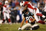 CHARLOTTE, NC - JANUARY 10: Dante Rosario #88 of the Carolina Panthers is tackled by Antrel Rolle #21 of the Arizona Cardinals during the NFC Divisional Playoff Game on January 10, 2009 at Bank of America Stadium in Charlotte, North Carolina.  (Photo by Kevin C. Cox/Getty Images)