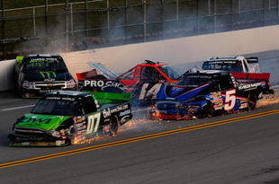 TALLADEGA, AL - OCTOBER 31:  Rick Crawford, driver of the #14 Circle Bar/International Truck Engine Ford, loses control and crashes into Mike Skinner, driver of the #5 PC Miler Navigator Toyota, during the NASCAR Camping World Truck Series Mountain Dew 250 at Talladega Superspeedway on October 31, 2009 in Talladega, Alabama.  (Photo by Sam Greenwood/Getty Images)