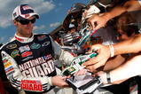 BROOKLYN, MI - AUGUST 14:  Dale Earnhardt Jr., driver of the #88 AMP Energy/National Guard Chevrolet, signs autographs for fans after qualifying for the NASCAR Sprint Cup Series Michigan 400 at Michigan Internetional Speedway on August 14, 2009 in Brooklyn, Michigan.  (Photo by Jason Smith/Getty Images)