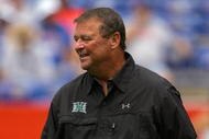 GAINESVILLE, FL - AUGUST 30: Head coach Greg McMackin of the Hawaii Warriors sends in signals during the game against the Florida Gators at Ben Hill Griffin Stadium on August 30, 2008 in Gainesville, Florida. (Photo by Sam Greenwood/Getty Images)