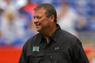 GAINESVILLE, FL - AUGUST 30: Head coach Greg McMackin of the Hawaii Warriors sends in signals during the game against the Florida Gators at Ben Hill Griffin Stadium on August 30, 2008 in Gainesville, Florida. (Photo by Sam Greenwood/Getty Images)