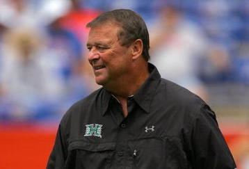GAINESVILLE, FL - AUGUST 30:  Head coach Greg McMackin of the Hawaii Warriors sends in signals during the game against the Florida Gators at Ben Hill Griffin Stadium on August 30, 2008 in Gainesville, Florida.  (Photo by Sam Greenwood/Getty Images)