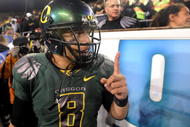 EUGENE, OR - OCTOBER 31: Quarterback Jeremiah Masoli #8 of the Oregon Ducks celebrates with fans on the sidelines as time runs down in the fourth quarter of the game against the USC Trojans at Autzen Stadium on October 31, 2009 in Eugene, Oregon. Masoli threw for 222 yards and a touchdown and ran for 164 more yards with another score as the Ducks upset the Trojans 47-20. (Photo by Steve Dykes/Getty Images)