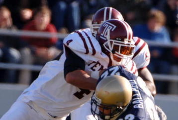 ANNAPOLIS, MD - NOVEMBER 19:  In this handout from the U.S. Navy, U.S. Naval Academy Midshipman full back Adam Ballard #22 is tackled by Temple Owls defender Justin Johnson #4 during the 1st quarter of play on November 19, 2005 at Navy Memorial Stadium in Annapolis, Maryland.  (Photo by Damon J. Moritz/U.S. Navy via Getty Images)