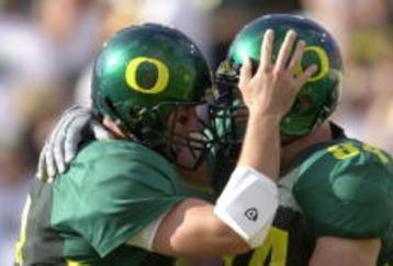01 Sep 2001: Quarterback Joey Harrington #3 (L) of the Oregon Ducks congratulates teammate Justin Peelle for scoring a touchdown against the Wisconsin Badgers during the Pac-10 game at Autzen Stadium in Eugene, Orgeon.  Oregon won 31-28. DIGITAL IMAGE. Mandatory Credit: Otto Greule/Allsport
