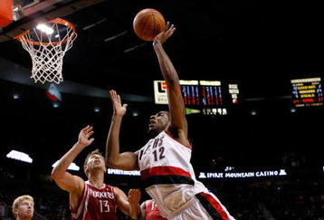 PORTLAND, OR - OCTOBER 27:  LaMarcus Aldridge #12 of the Portland Trail Blazers shoots over Carl Landry #14 of the Houston Rockets during the season opener on October 27, 2009 at the Rose Garden in Portland, Oregon. NOTE TO USER: User expressly acknowledges and agrees that, by downloading and or using this Photograph, user is consenting to the terms and conditions of the Getty Images License Agreement.  (Photo by Jonathan Ferrey/Getty Images)