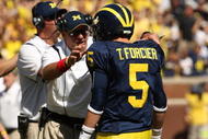 ANN ARBOR, MI - SEPTEMBER 19:  Head coach Rich Rodriguez of the Michigan Wolverines talks with quarterback Tate Forcier #5 during the game with the Eastern Michigan Eagles at Michigan Stadium on September 19, 2009 in Ann Arbor, Michigan.  Michigan won 45-17.  (Photo by Stephen Dunn/Getty Images)