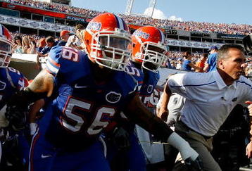 JACKSONVILLE, FL - OCTOBER 31:  Head coach Urban Meyer (R) of the Florida Gators leads his team onto the field to face the Georgia Bulldogs at Jacksonville Municipal Stadium on October 31, 2009 in Jacksonville, Florida.  (Photo by Kevin C. Cox/Getty Images)