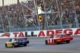 TALLADEGA, AL - NOVEMBER 01: Jamie McMurray, driver of the #26 IRWIN Marathon Ford, takes the checkered flag ahead of second place finisher Kasey Kahne, driver of the #9 Budweiser Dodge to win the NASCAR Sprint Cup Series AMP Energy 500 at Talladega Superspeedway on November 1, 2009 in Talladega, Alabama.  (Photo by Jerry Markland/Getty Images for NASCAR)